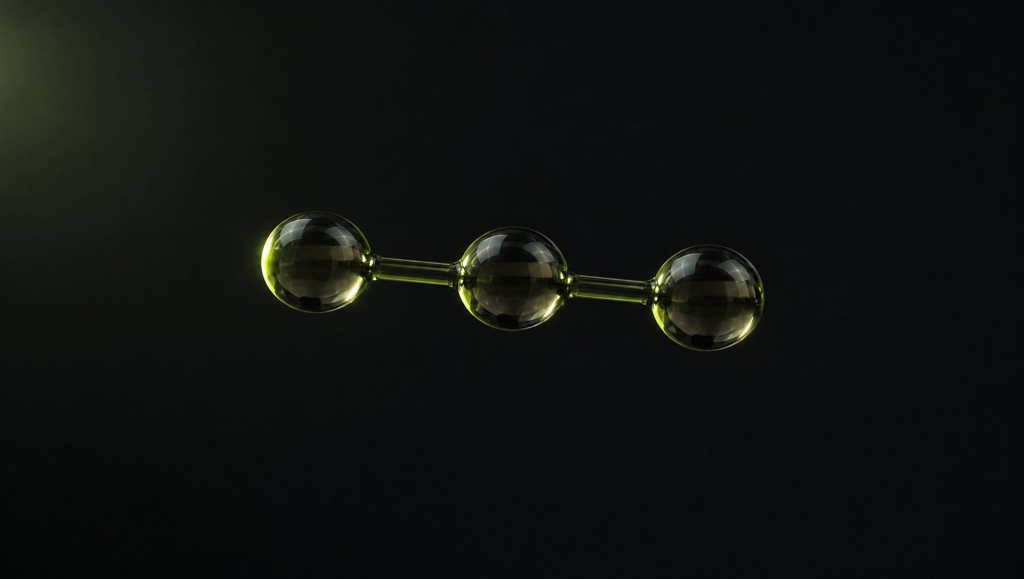 Three smoky glass beads joined in a short straight row by thin glass rods, floating against black with olive-green edge light.
